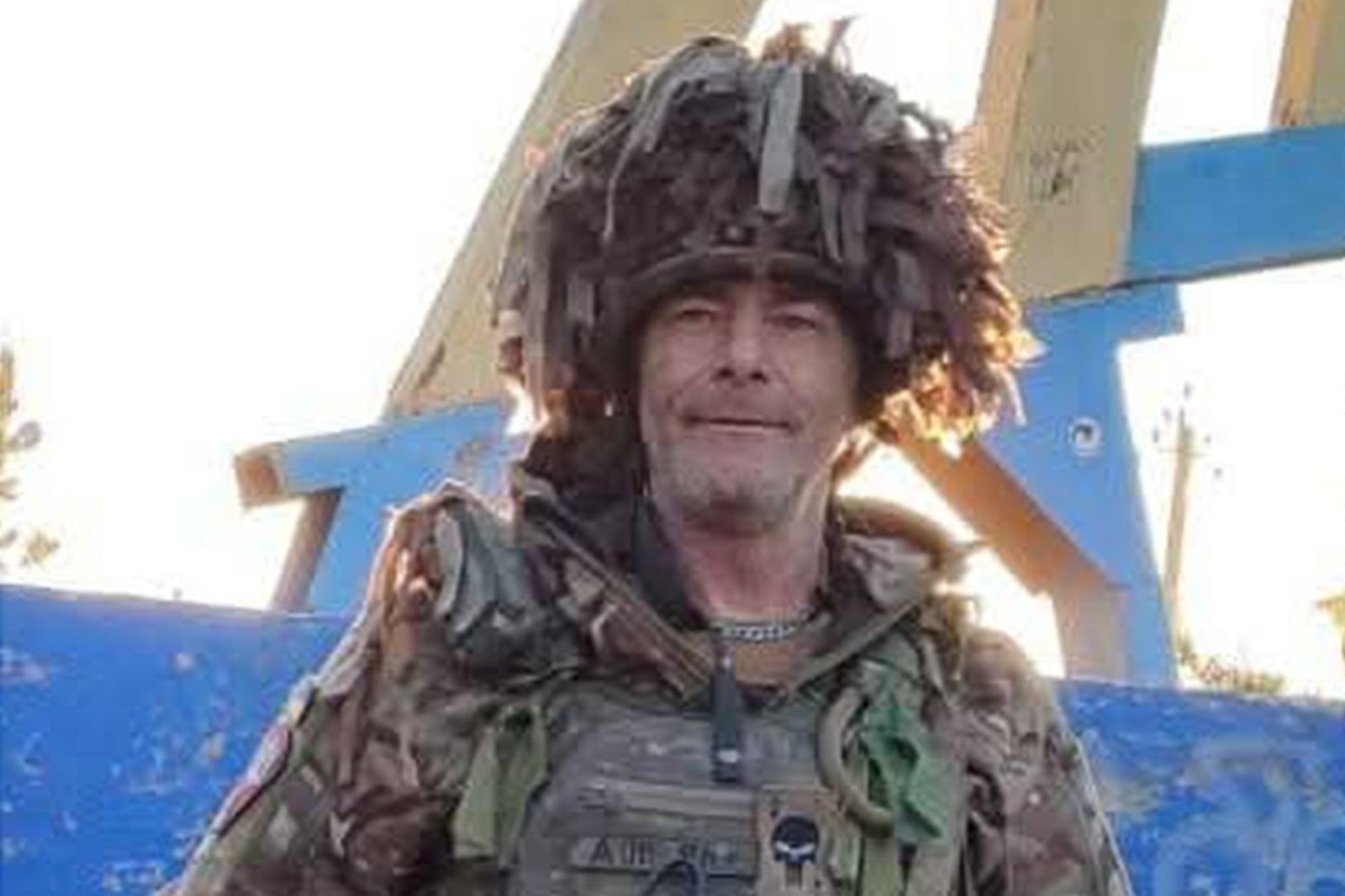 <p>Brit volunteer Drew Scott at the entrance to the town of Yampil in Donetsk region</p>