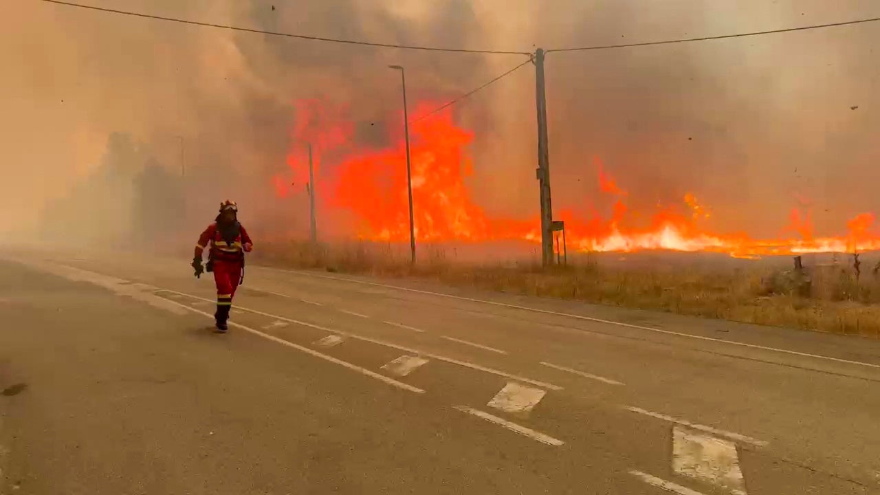 Military firefighters tackling a wildfifre near Yeres, northwestern Spain
