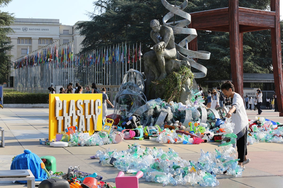 Artist drowns sculpture in plastic waste in front of the UN during plastic pollution treaty talks