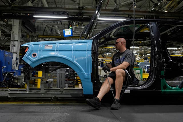 <p>A vehicle assembly technician works on a 2025 Ford Expedition. Ford recalled more than 200,000 vehicles in late October, citing safety concerns</p>