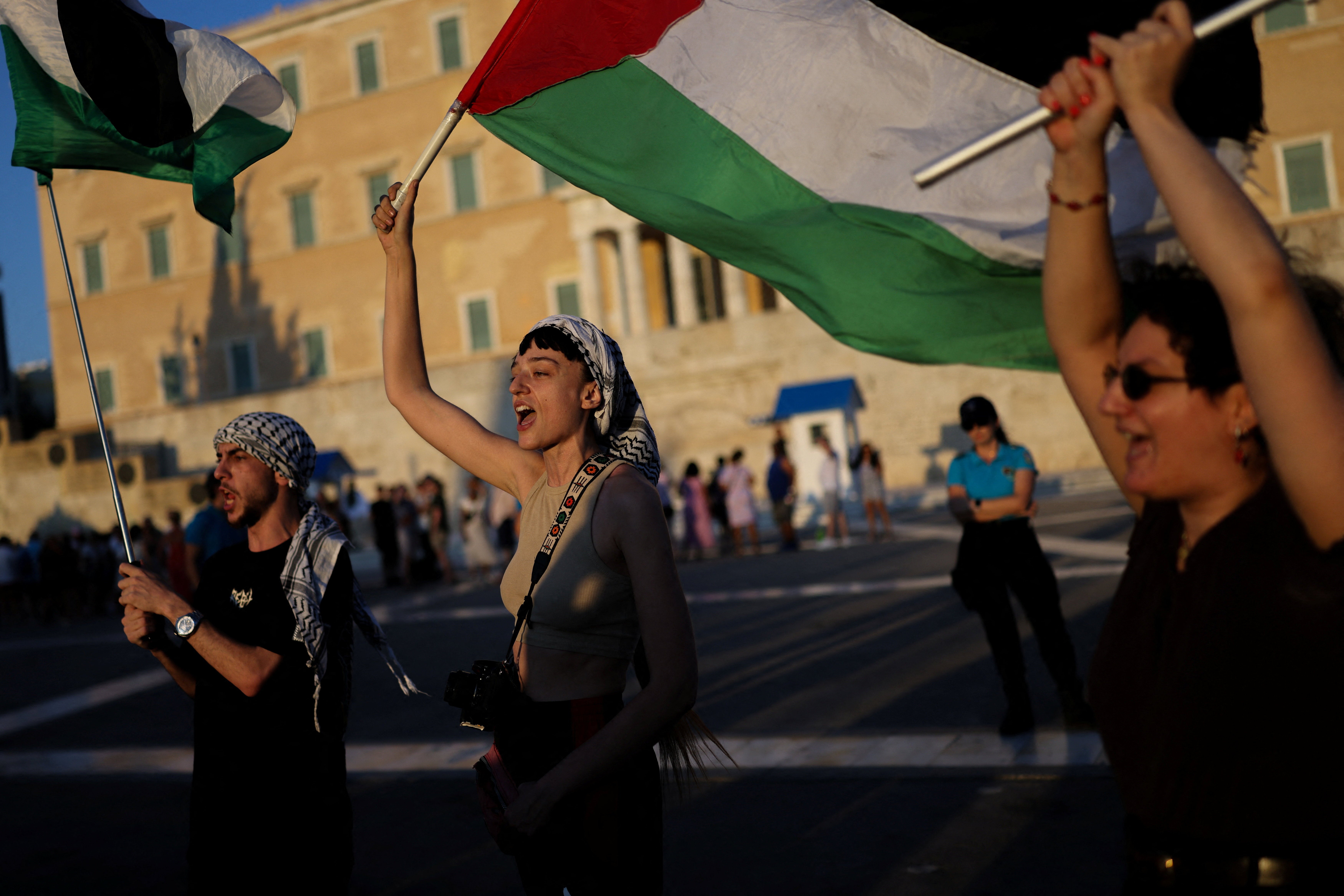 Pro-Palestinian protesters shout slogans in front of the Greek Parliament during a protest