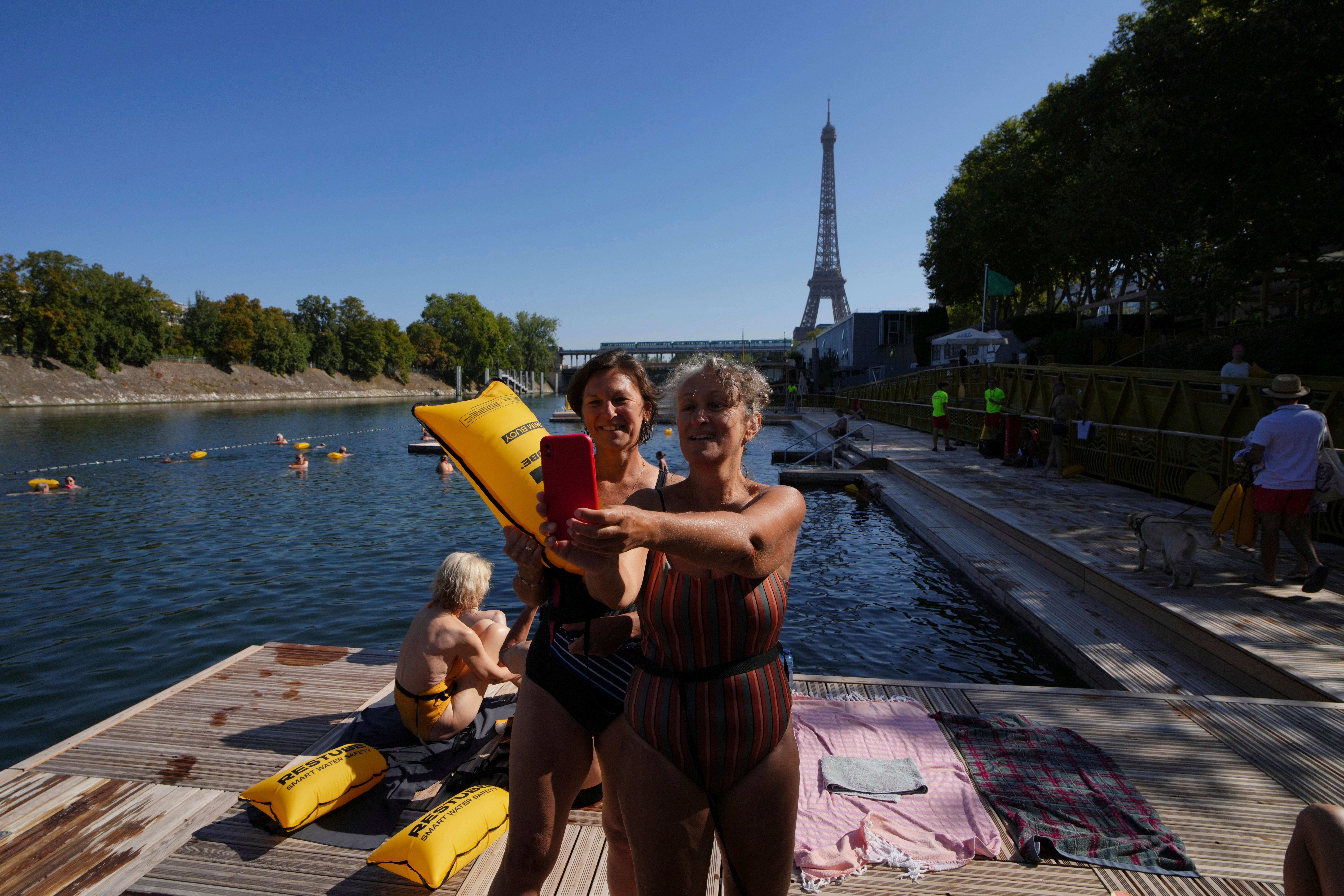 Swimmers take a selfie with the Eiffel Tower in the background