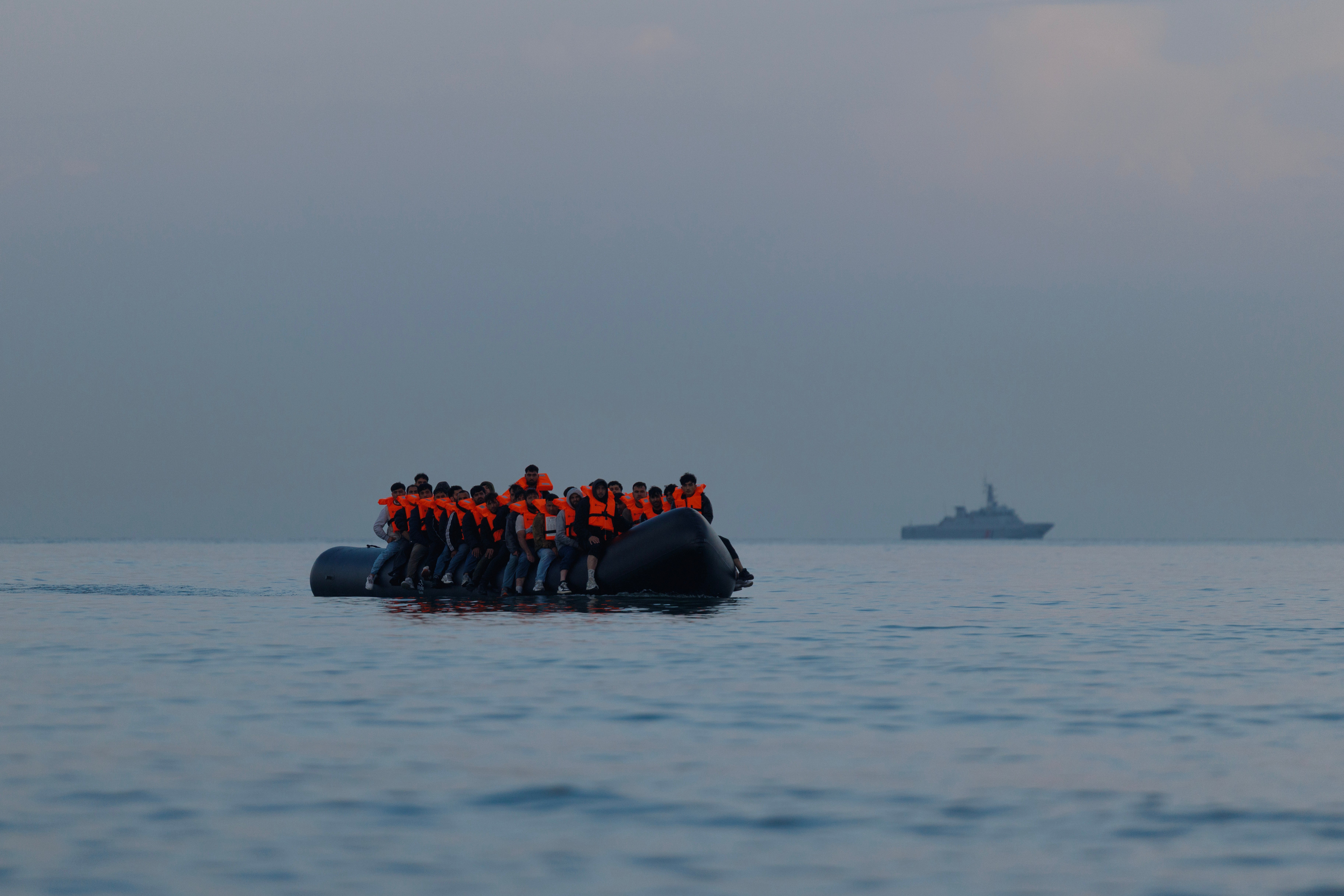 A small boat arrives to collect more migrant families from the beach on August 12, 2025 in Gravelines, France.