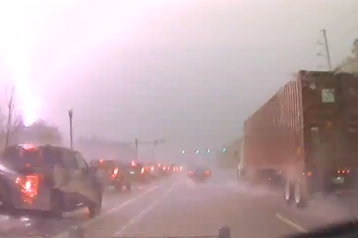 Bolt of lighting hits transformer by busy highway causing huge fireball in dramatic footage