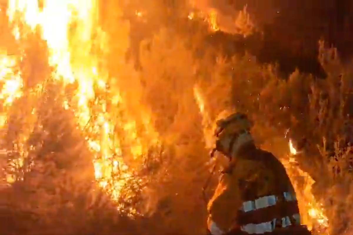 Firefighters come dangerously close to wildfires as they tear through northwestern Spain