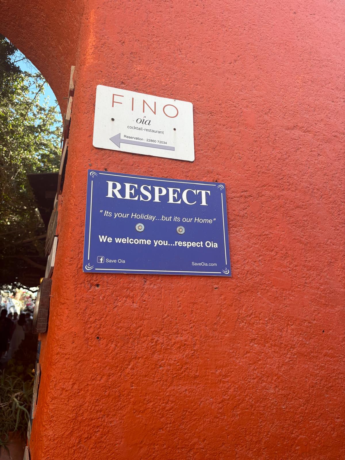 A sign up in Santorini asking visitors to respect Oia