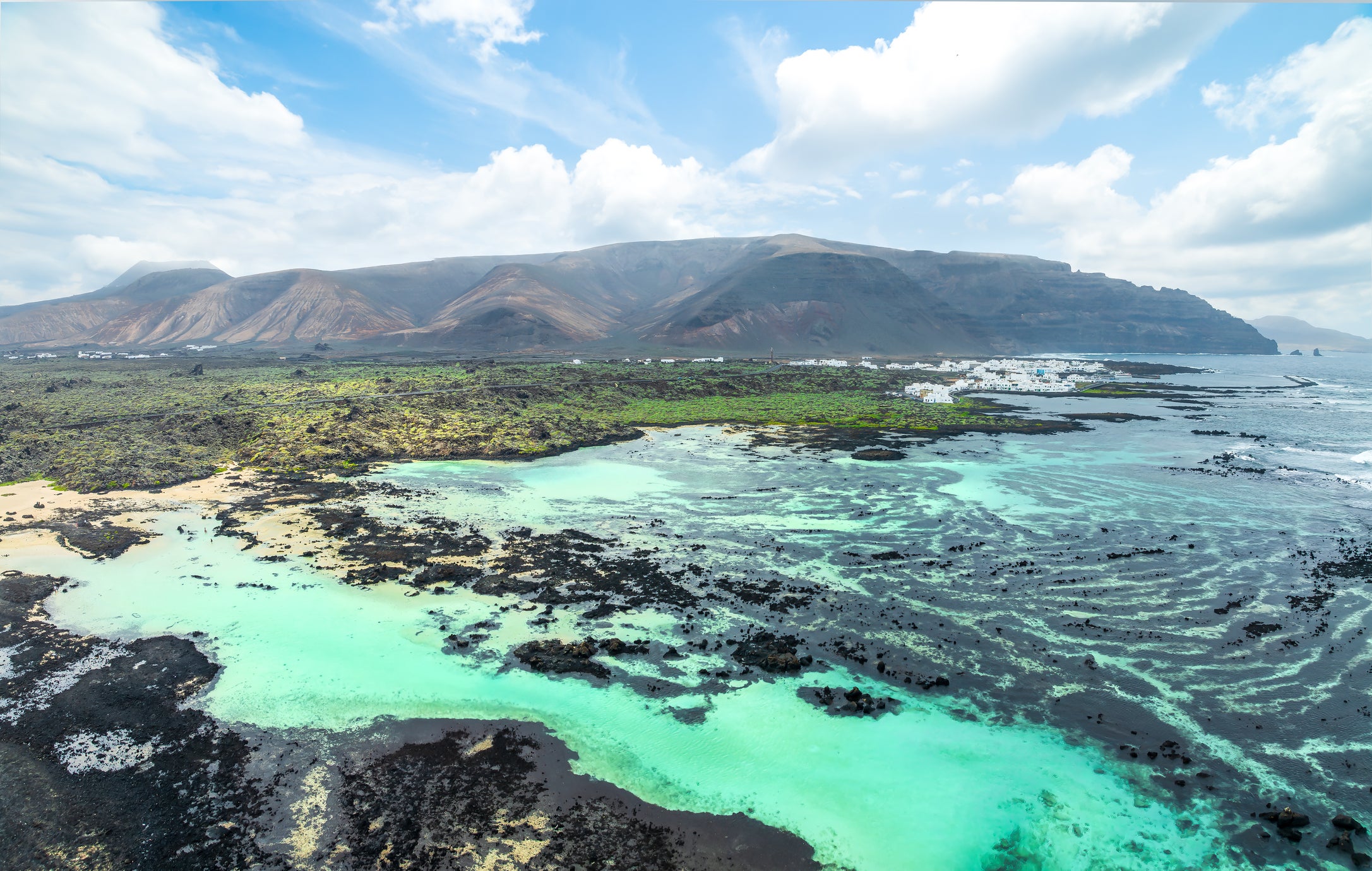 Caleton Blanco beckons with a string of white sand coves between its turquoise waters