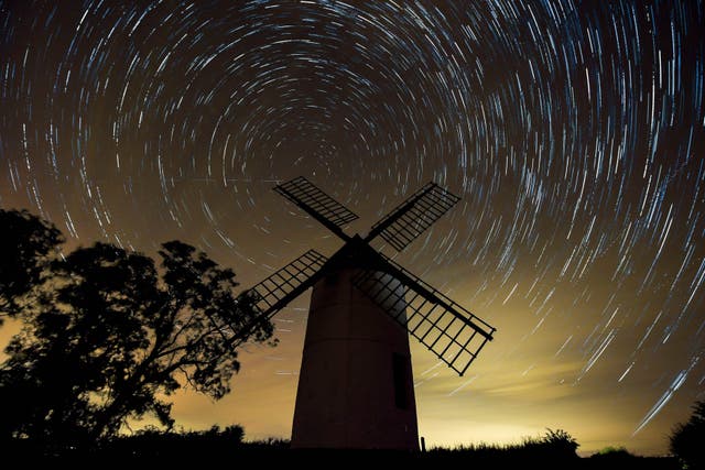 A composite image made from 726 photographs taken over three hours from midnight showing the rotation of the earth around Polaris, the North Star, in the night sky over Ashton Windmill, Somerset (Ben Birchall/PA)