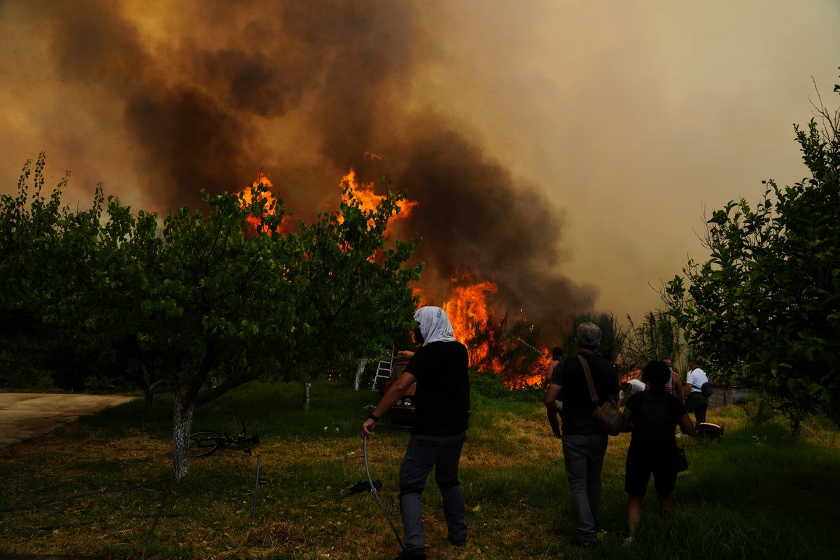 At least 3 dead and thousands displaced as wildfires rage across southern Europe