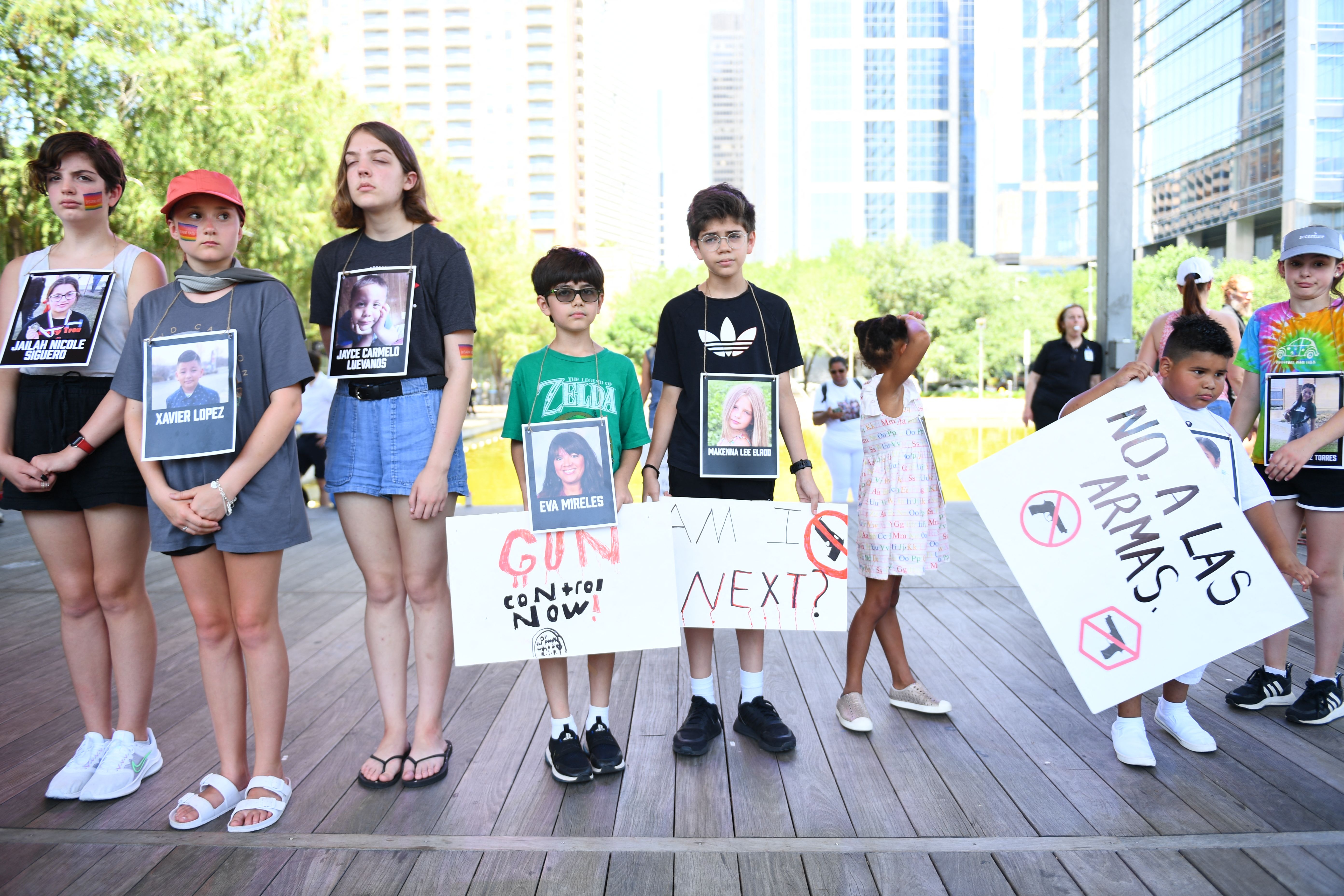 Texas children pose with signs following a deadly school shooting in Uvalde in 2022. Many children are worrying about school gun violence