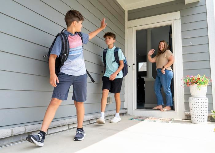 Ohio mom Kelley McChristy waves goodbye to her sons before school. McChristy and other parents have been dealing with school avoidance.