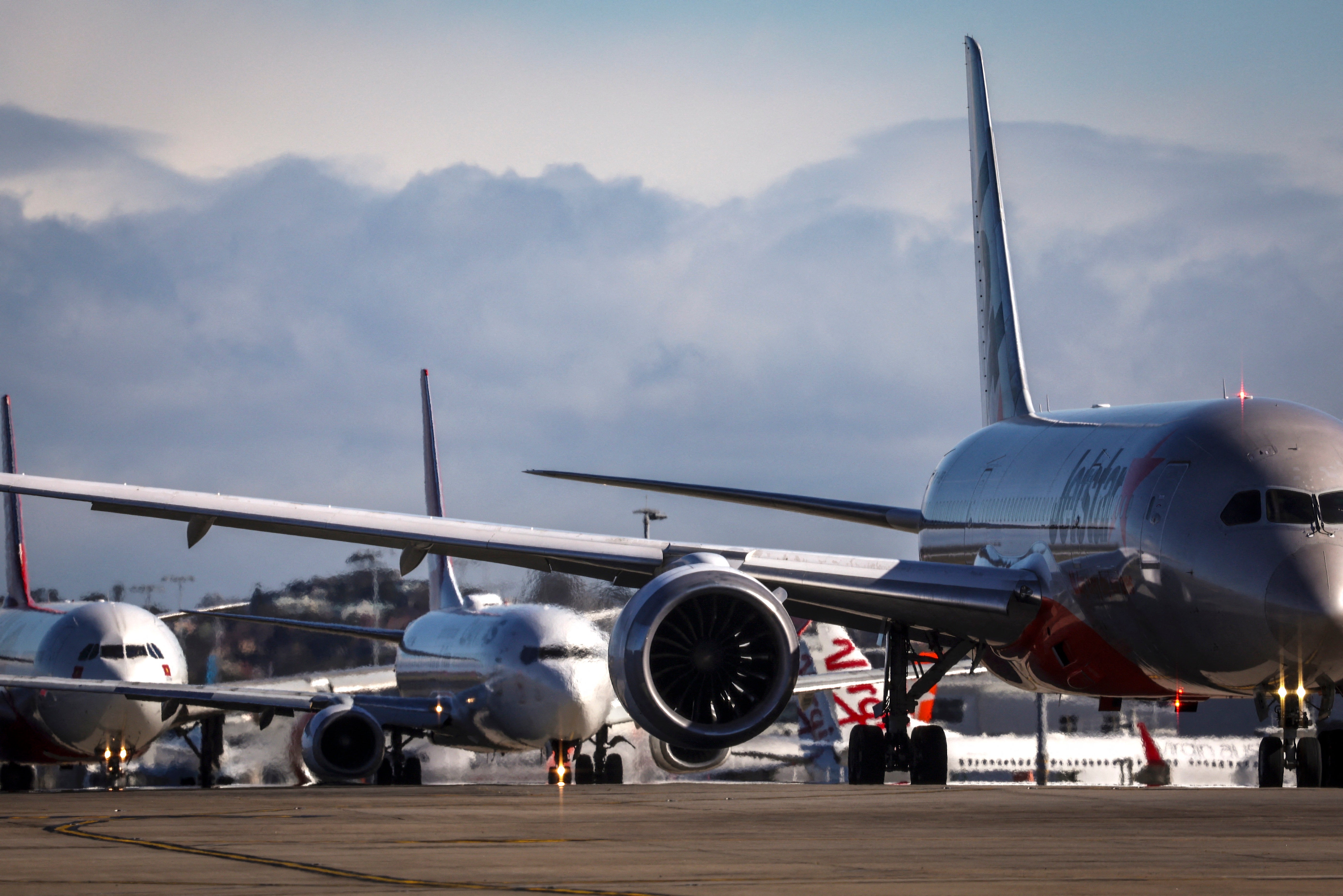 Aircrafts line up at Sydney International Airport on 25 June 2025