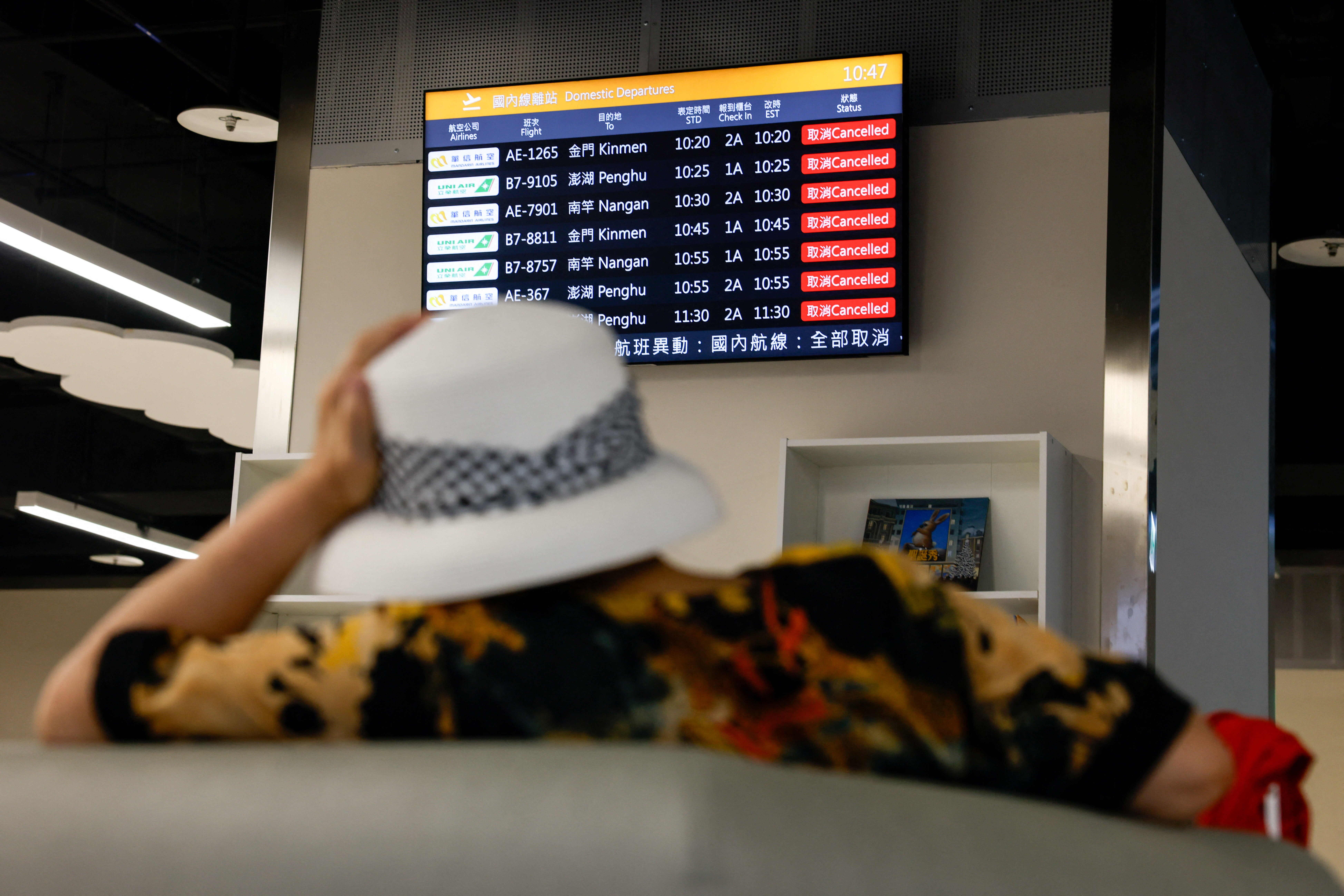 Flight cancellations and evacuations as Typhoon Podul makes landfall in Taiwan A woman sits in front of a screen displaying information on cancelled domestic flights, as Typhoon Podul approaches the country, in Taipei, Taiwan