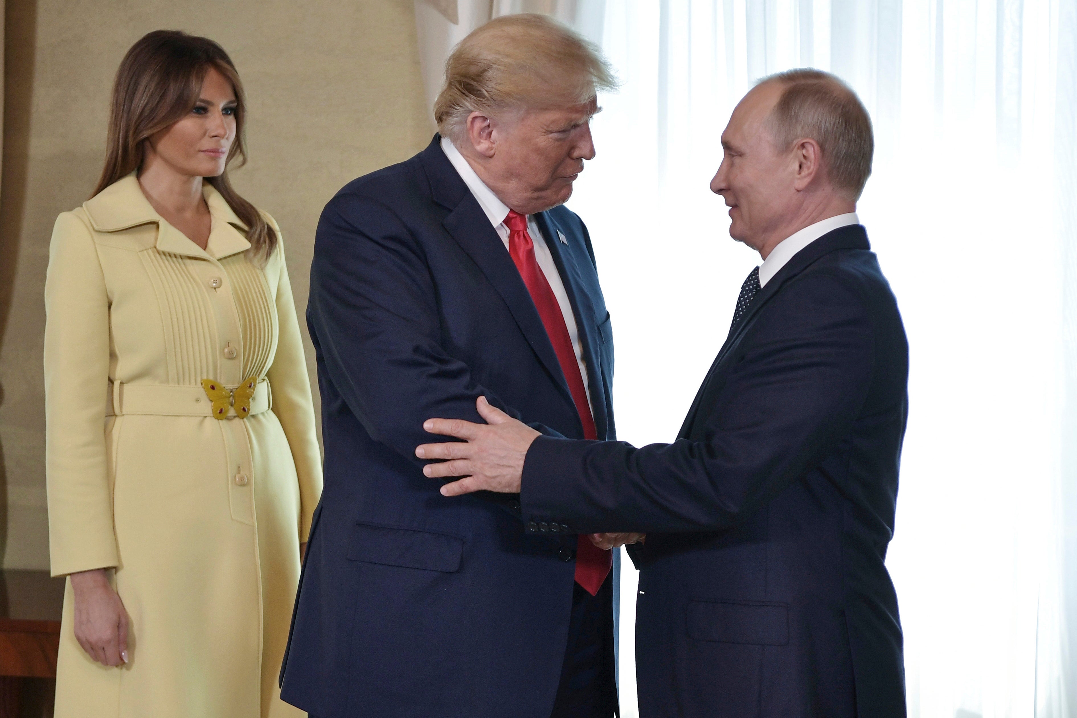 The First Lady of the United States, Melania Trump, looks on as President Donald Trump and his Russian counterpart, Vladimir Putin, greet each other before a face-to-face meeting at the Presidential Palace in Helsinki, Finland, on July 16, 2018.