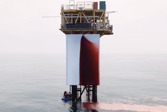 The canvas was sprayed with 1,000 litres of red liquid by the activists (Greenpeace/PA)