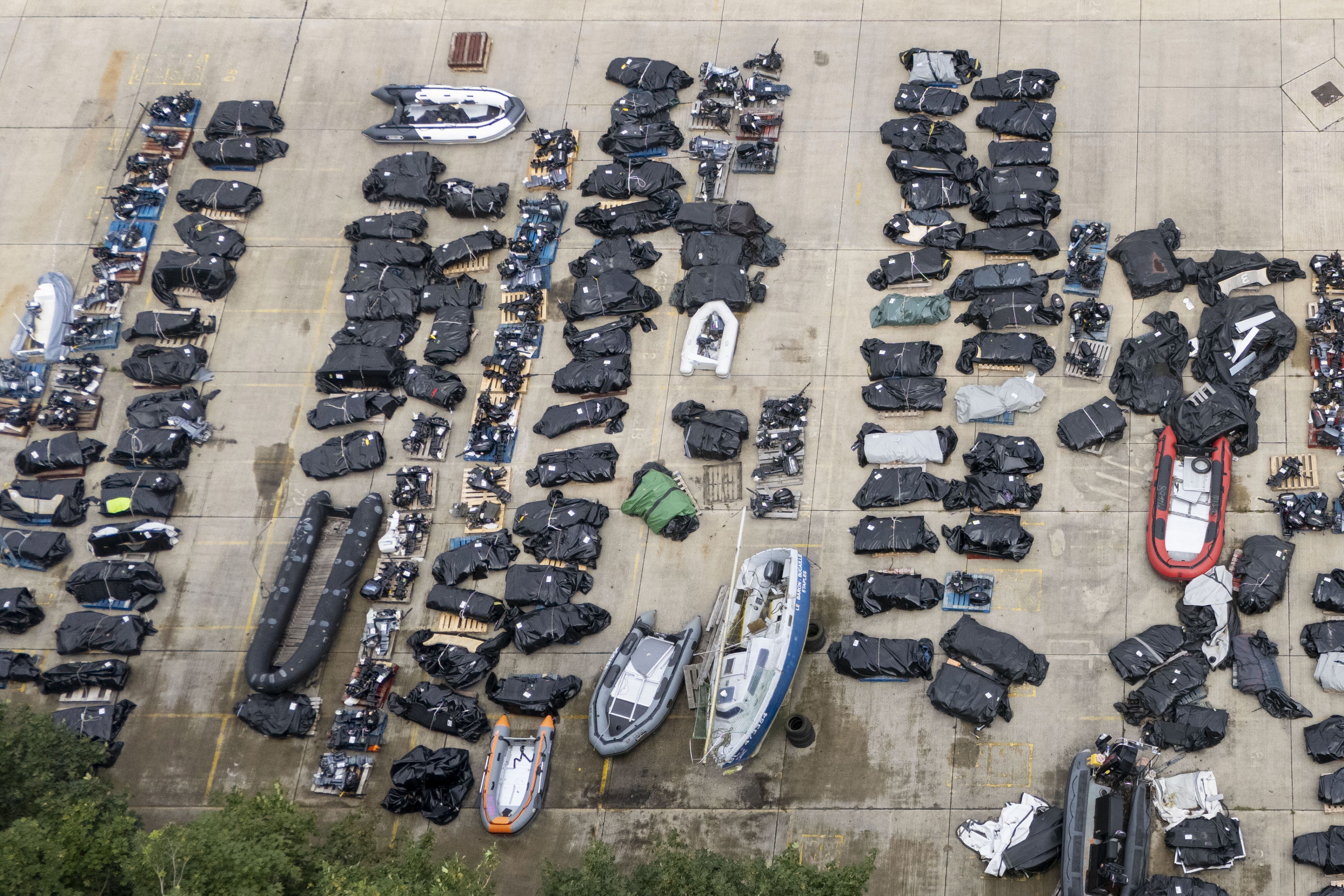 Small boats and outboard motors used by people thought to be migrants to cross the Channel from France at a storage facility in Dover, Kent (Gareth Fuller/PA)