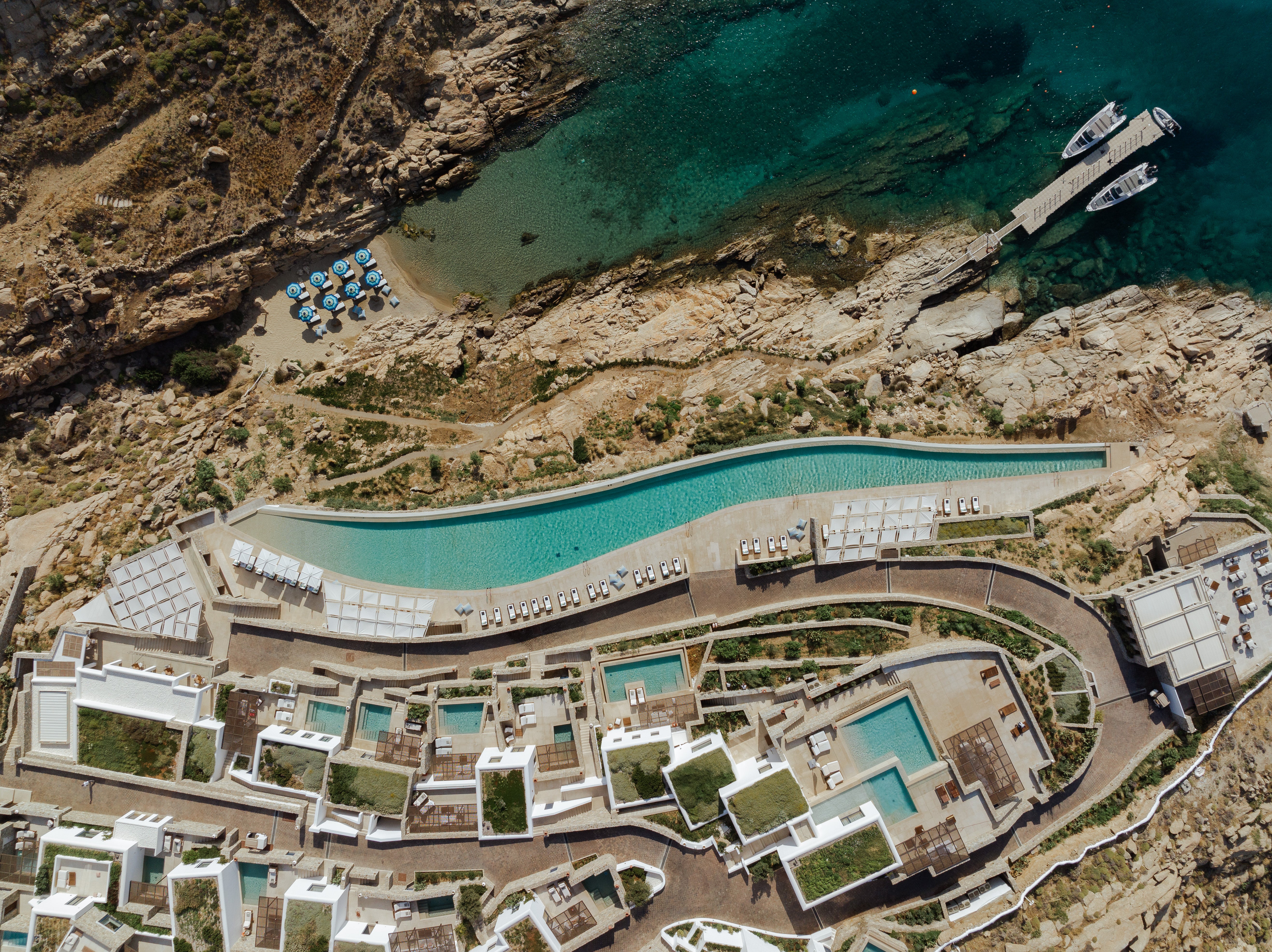 <p>The hotel is nestled into a hillside on the Kalafati coast </p>