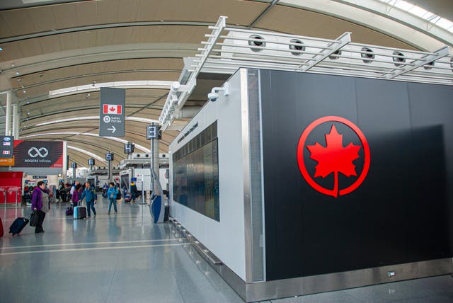 <p>People walking with luggage at the Terminal 1, Pearson International Airport, Toronto</p>