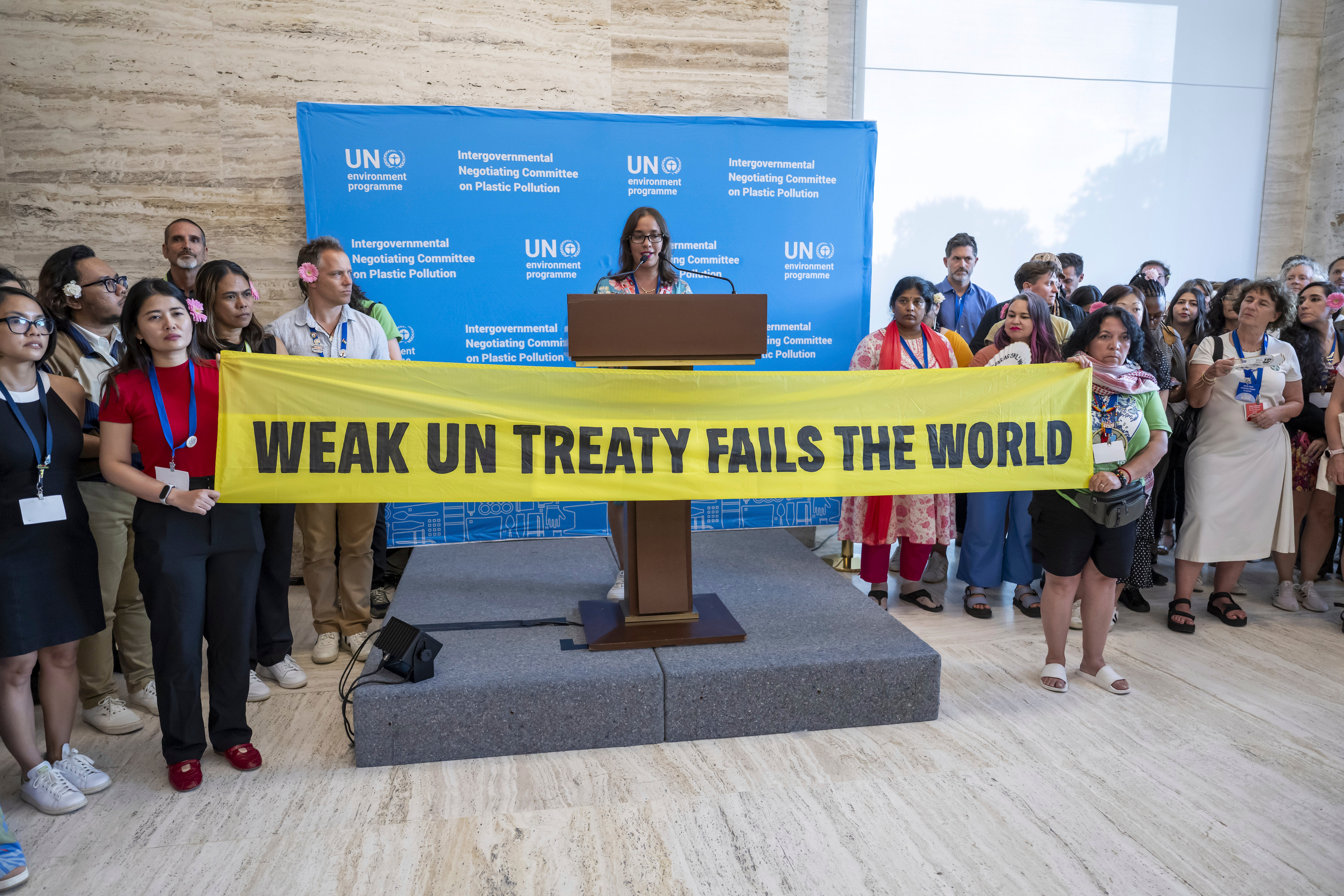 Activists stage a protest during the Plastic Pollution negotioations at the United Nations headquarters in Geneva, Switzerland on Thursday, 14 August