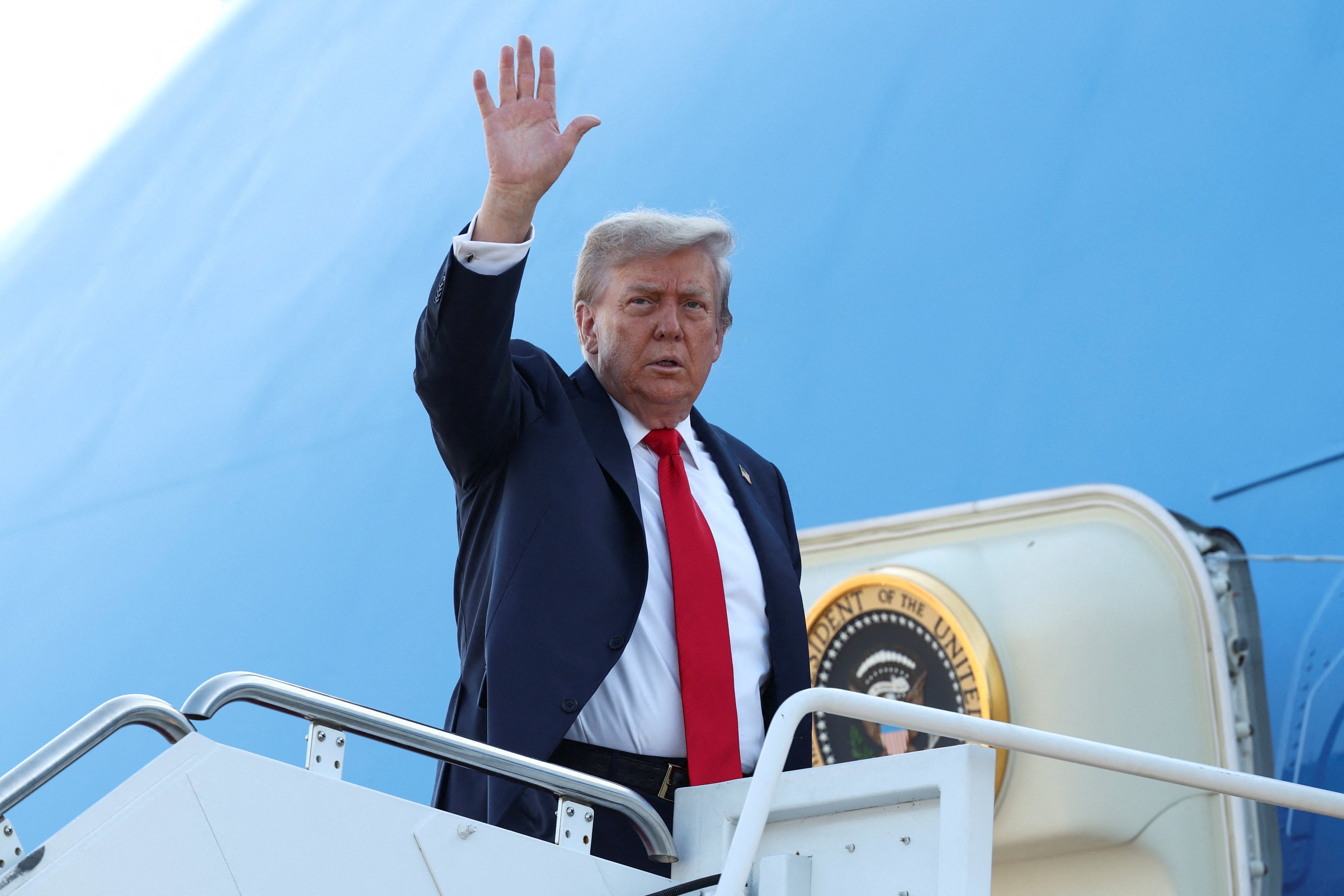 Trump waved to reporters as he got on Air Force One
