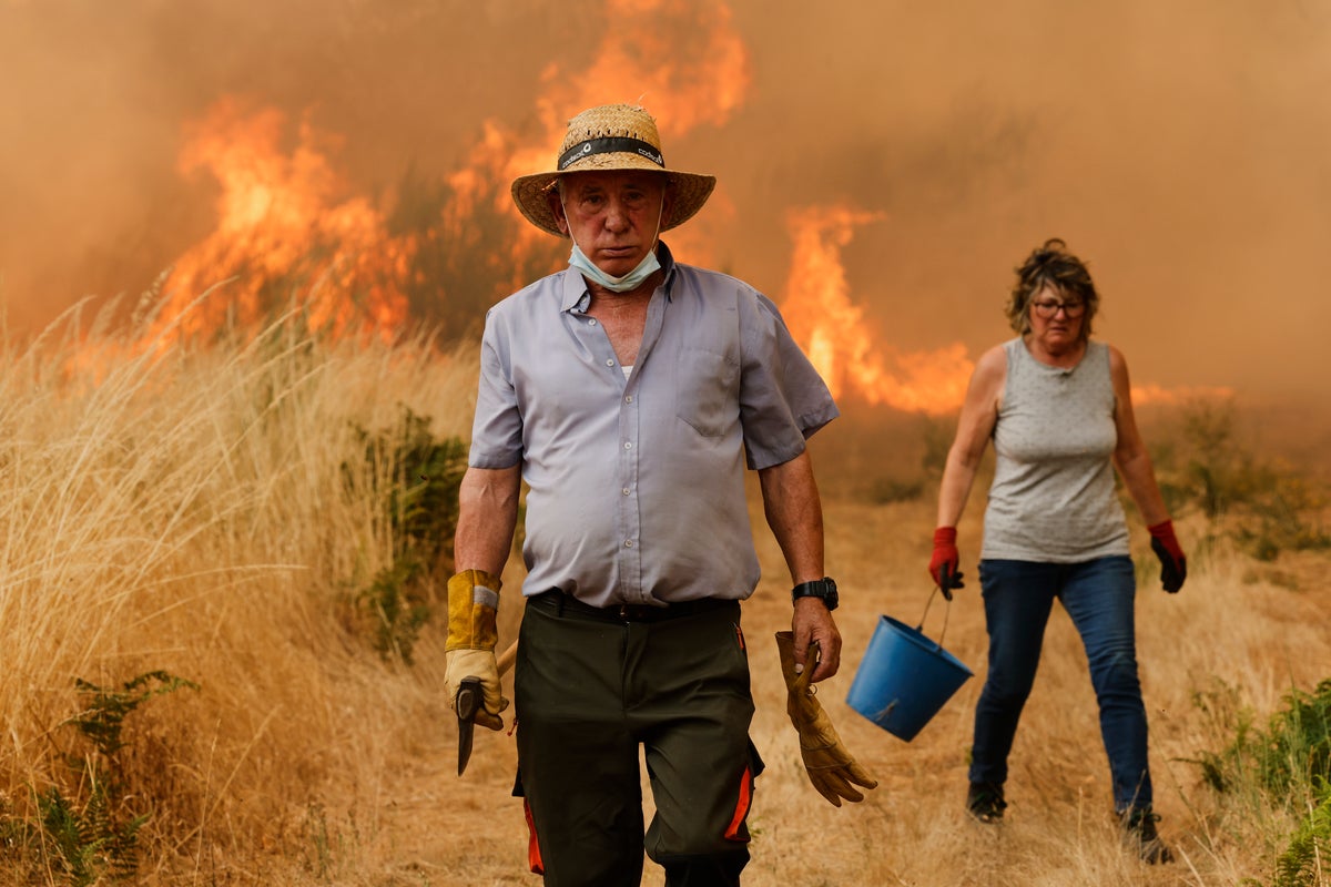 Photos of the wildfires in Europe displacing thousands as residents join efforts to fight the flames