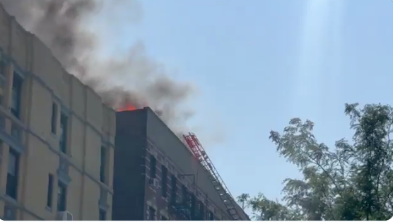 FDNY members are working to put out a three-alarm fire at 305 East 95th Street in Manhattan