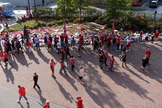 Fans gather beside tributes for Diogo Jota outside the stadium