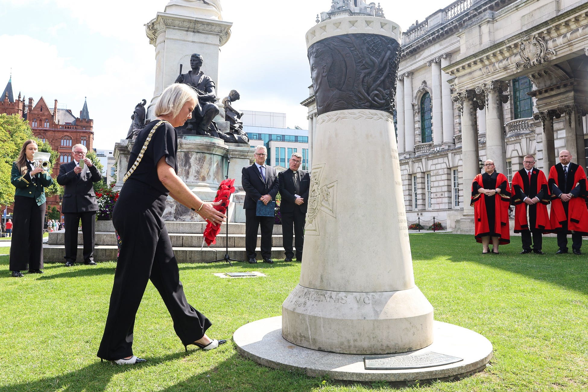 The Lord Mayor of Belfast, Tracy Kelly, places a wreath at the memorial to VC James Magennis in the grounds of City Hall (Belfast City Council/PA)