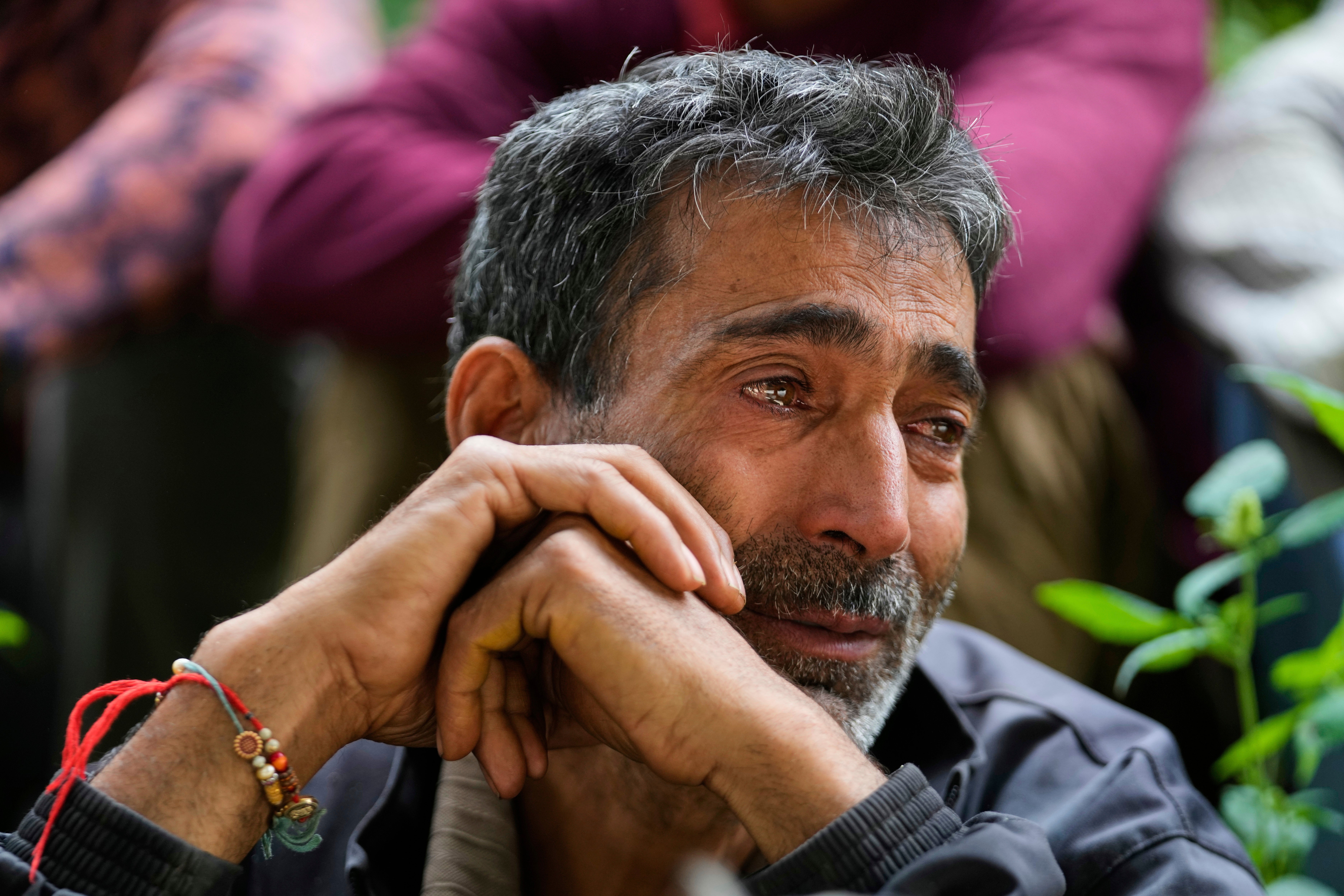 Hari Chand mourns the death of his wife during flash floods in Chositi village, in Kishtwar district, Indian-controlled Kashmir, Friday, Aug. 15, 2025. (AP Photo/Channi Anand)