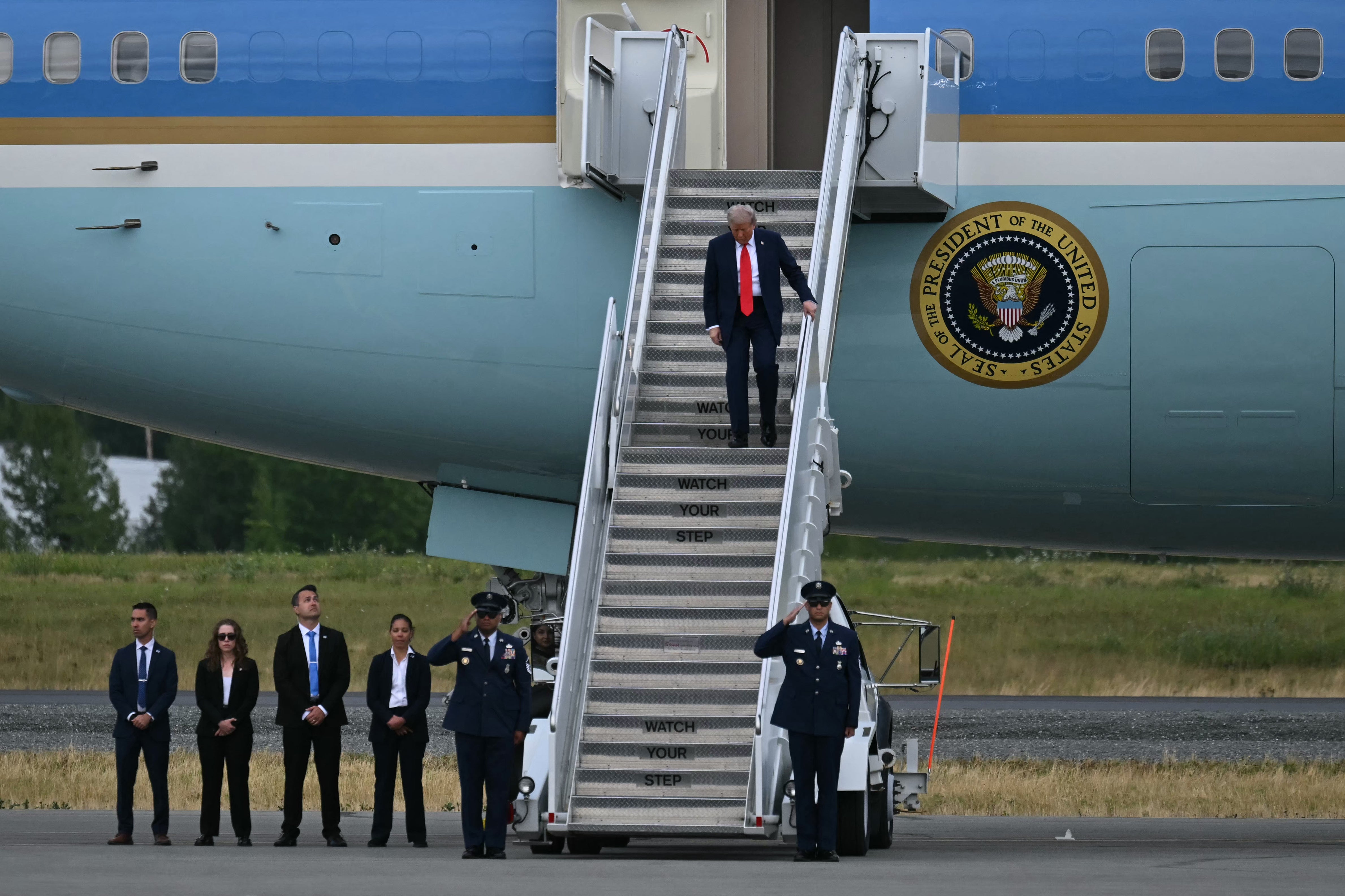President Donald Trump steps off of Air Force One upon arrival at Joint Base Elmendorf-Richardson in Anchorage, Alaska