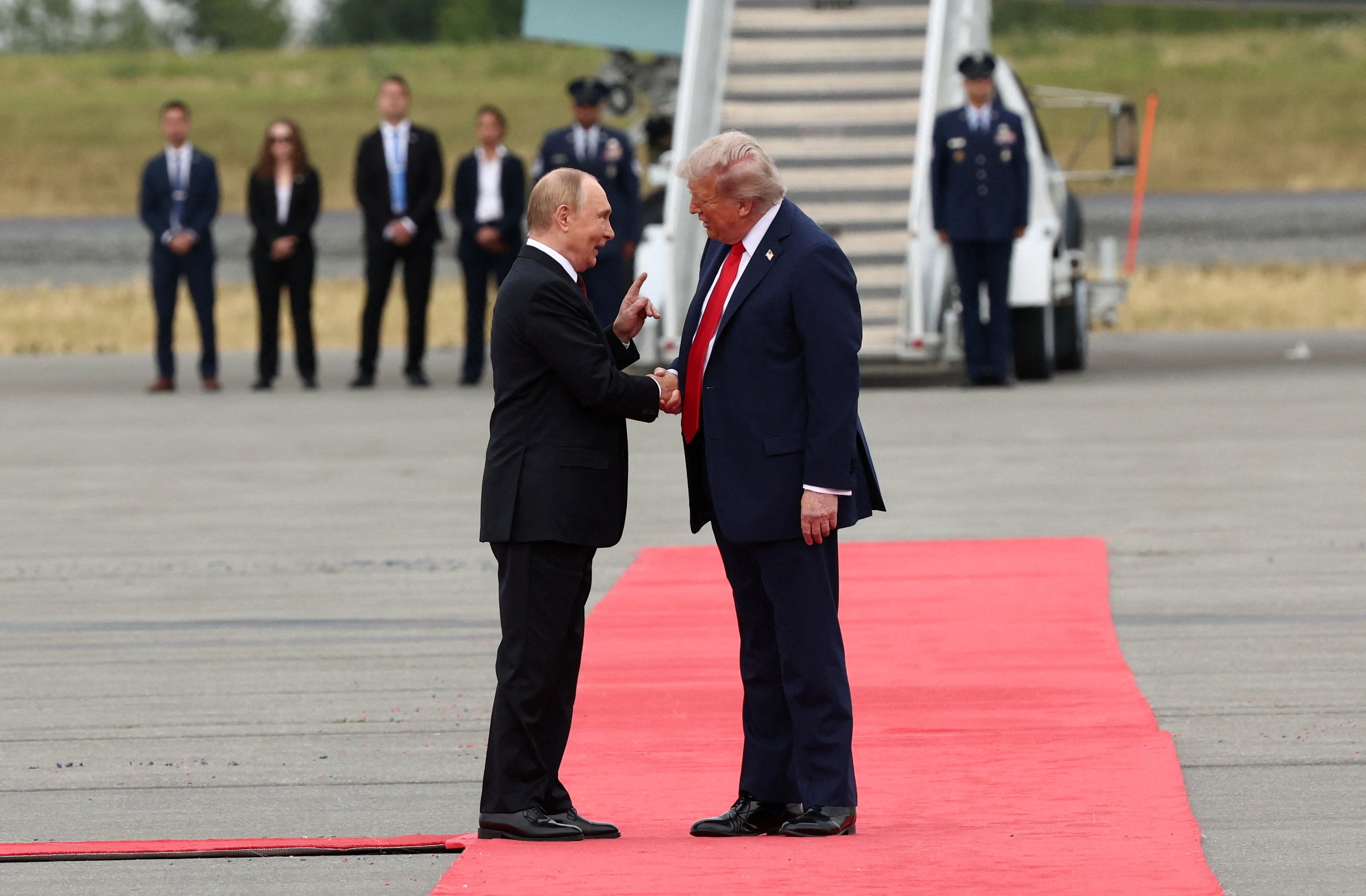 President Donald Trump shakes hand with Russian President Vladimir Putin, as they meet to negotiate for an end to the war in Ukraine
