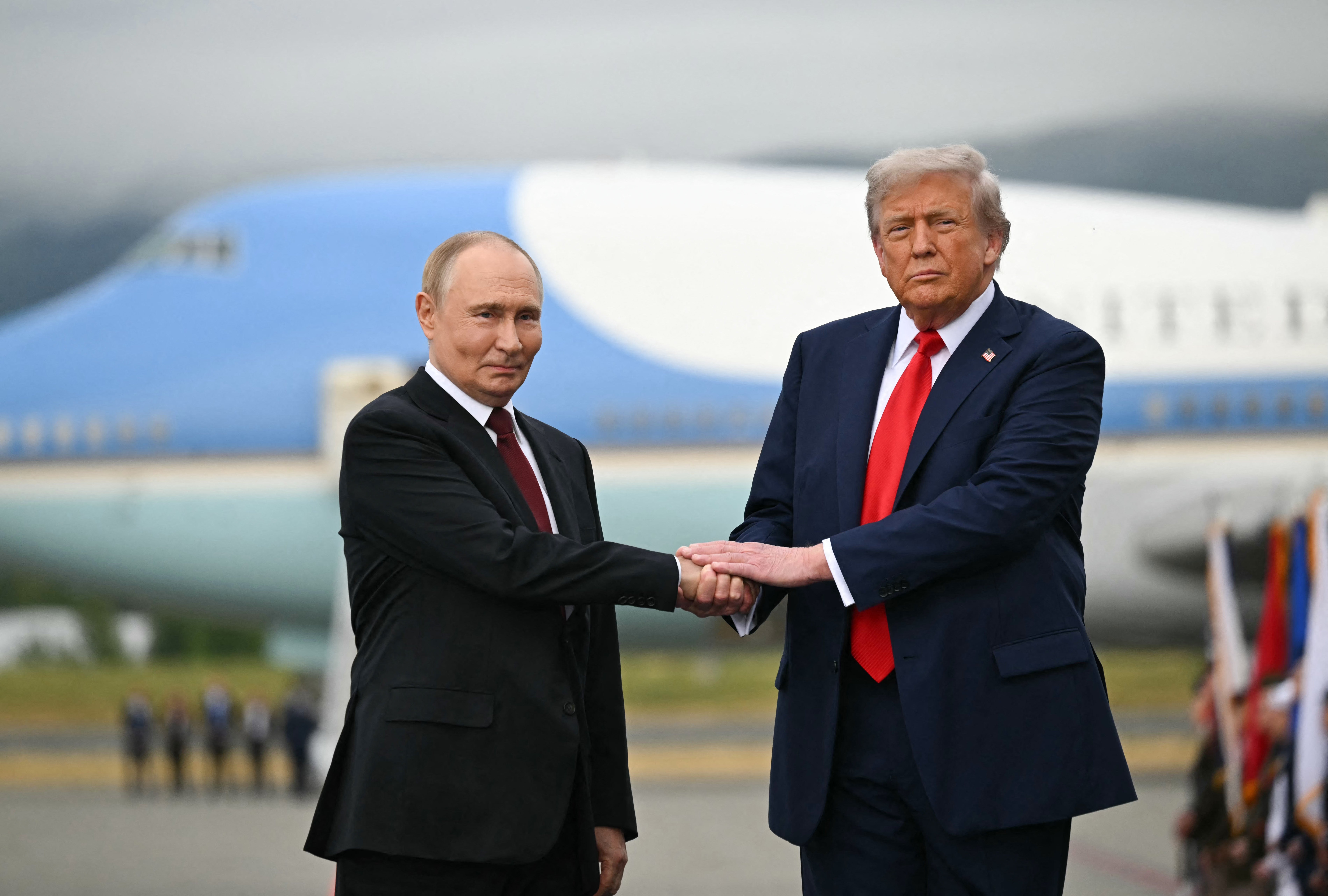 Like old friends catching up for the first time in ages, Vladimir Putin and Donald Trump met warmly on the tarmac of a US military base in Alaska Friday.