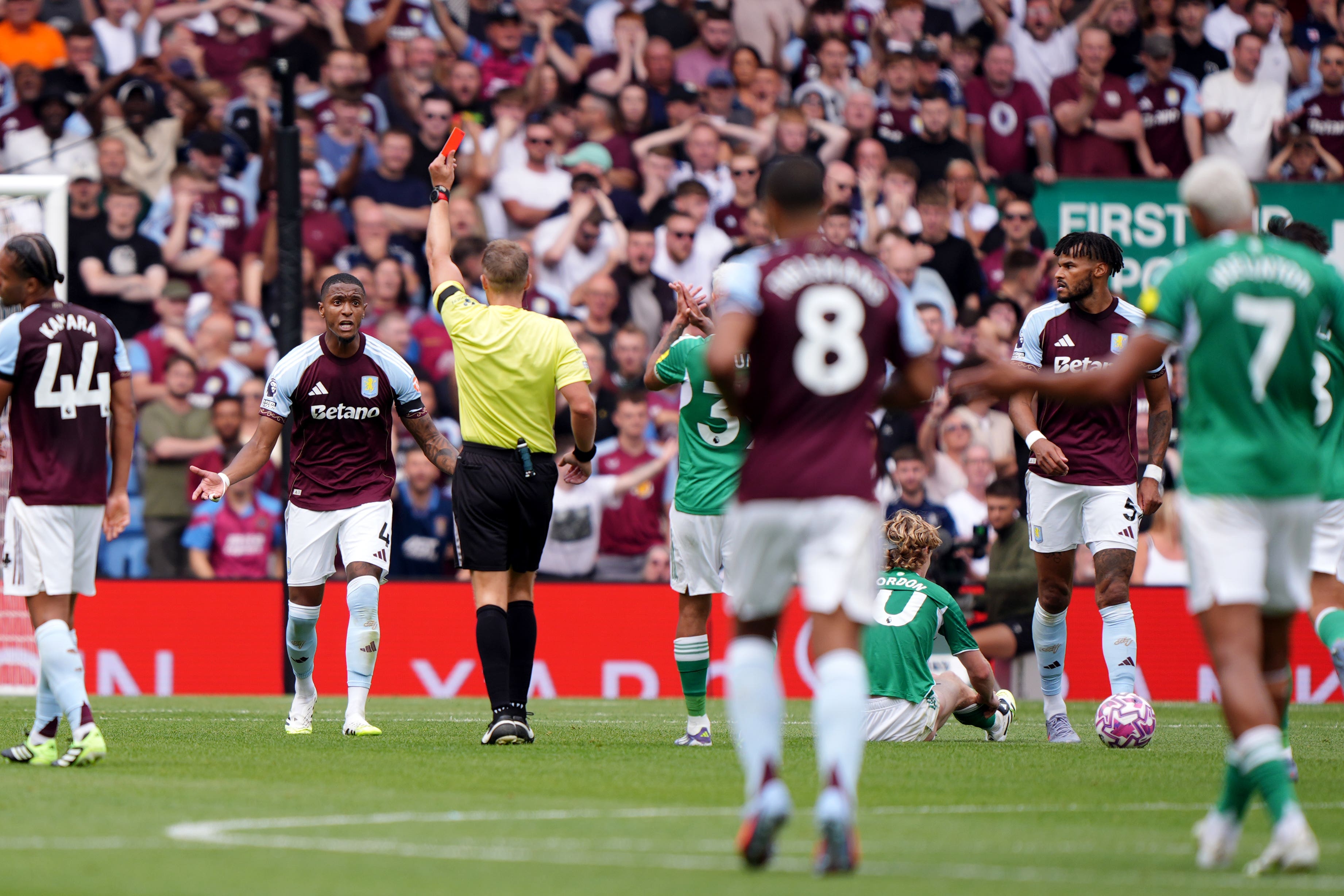 Konsa is shown a red card by referee Craig Pawson