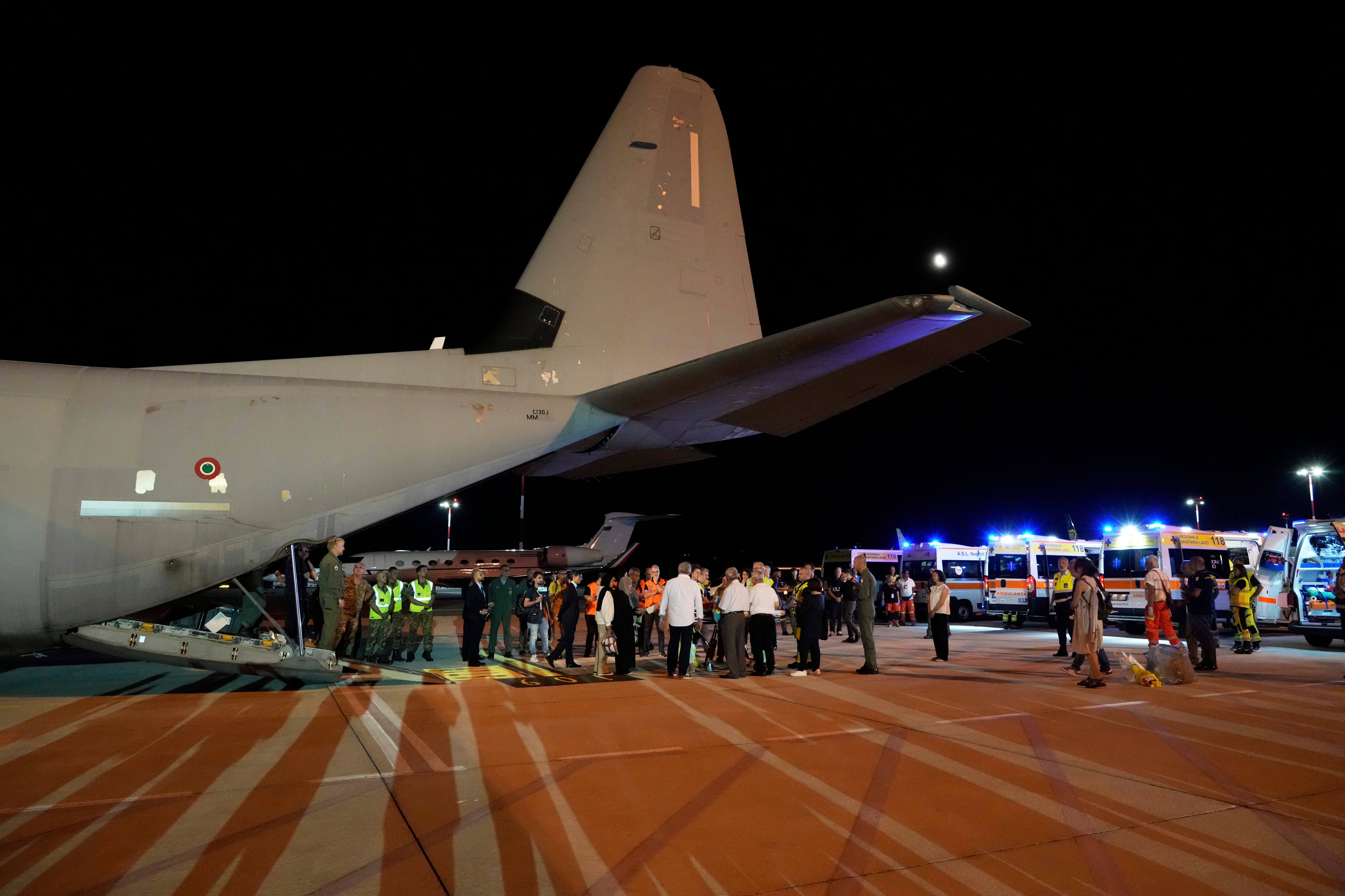 Palestinian children and their families evacuated from Gaza arrive at Rome's Ciampino military airport, Thursday, Aug. 14, 2025. (AP Photo/Gregorio Borgia)