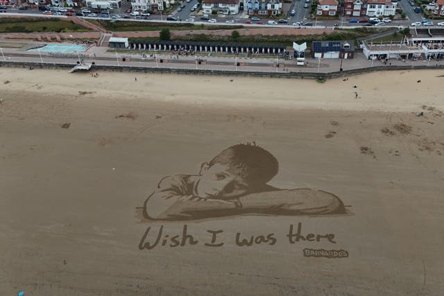 The giant sand portrait was commissioned to highlight how millions of children in the UK are missing out on days out, Barnardo’s said (Richard McCarthy/PA)