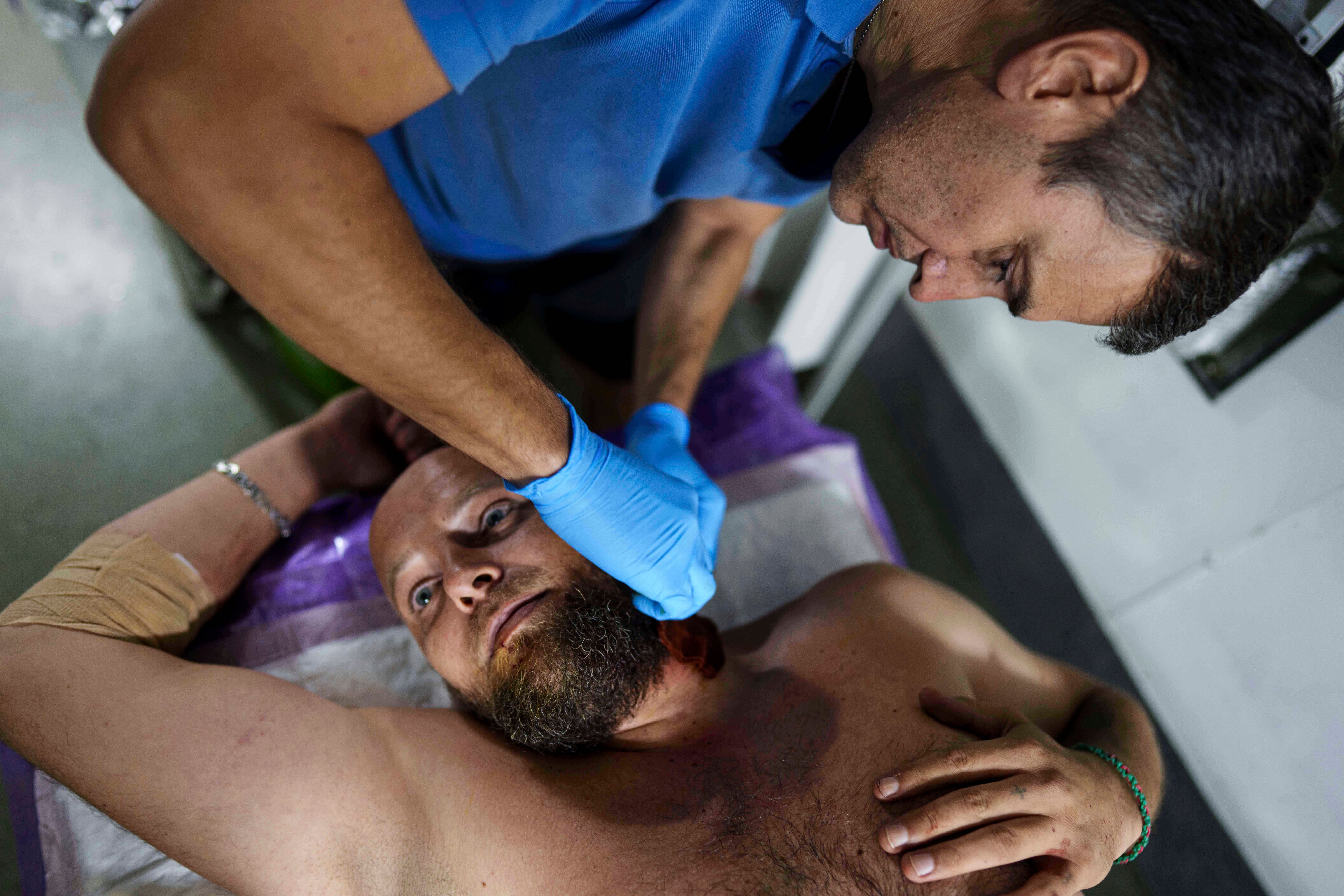 A Ukrainian military doctor from the 59th brigade treats his comrade injured at a stabilization point not far from the front line on Pokrovsk Direction, Ukraine, Saturday August 9, 2025. (AP photo / Evgeniy Maloletka)