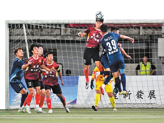 <p>Nanchang and Jingdezhen players compete during the opening match of the Jiangxi Super League on 13 July in Nanchang, Jiangxi province</p>