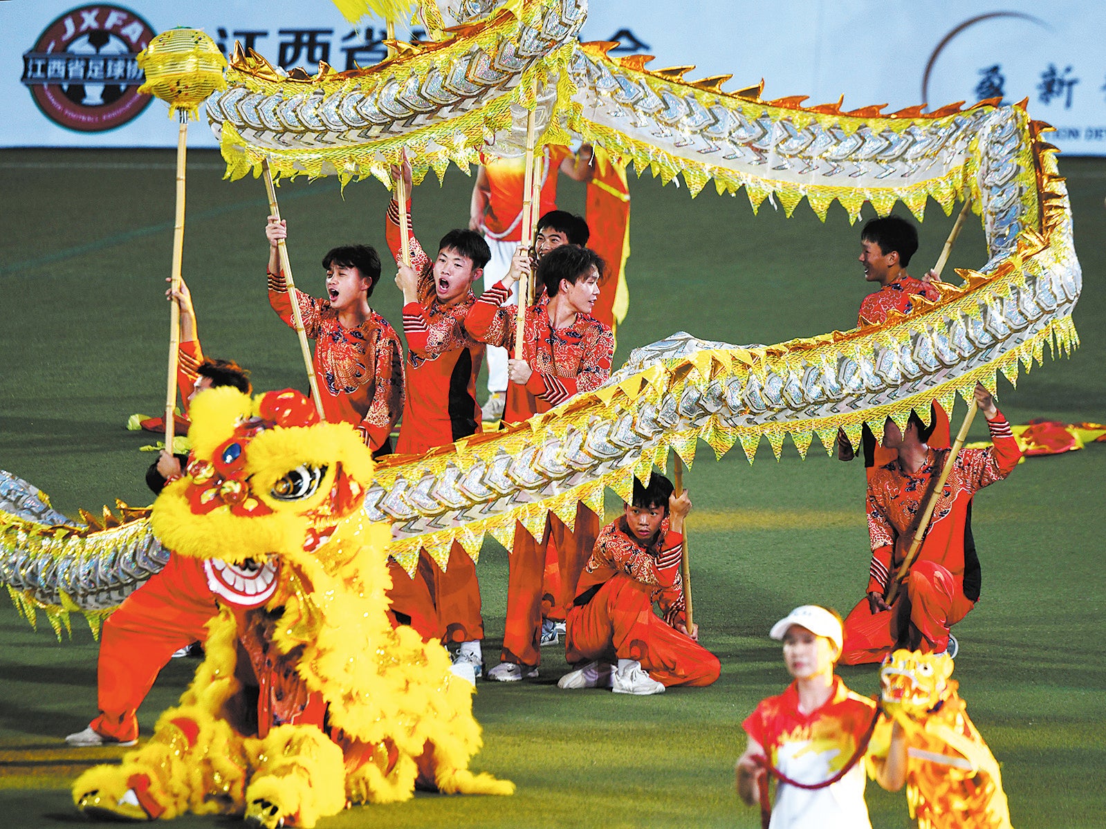 A lion dance performance entertains the crowd during the opening ceremony of the Jiangxi Super League in Nanchang on 12 July
