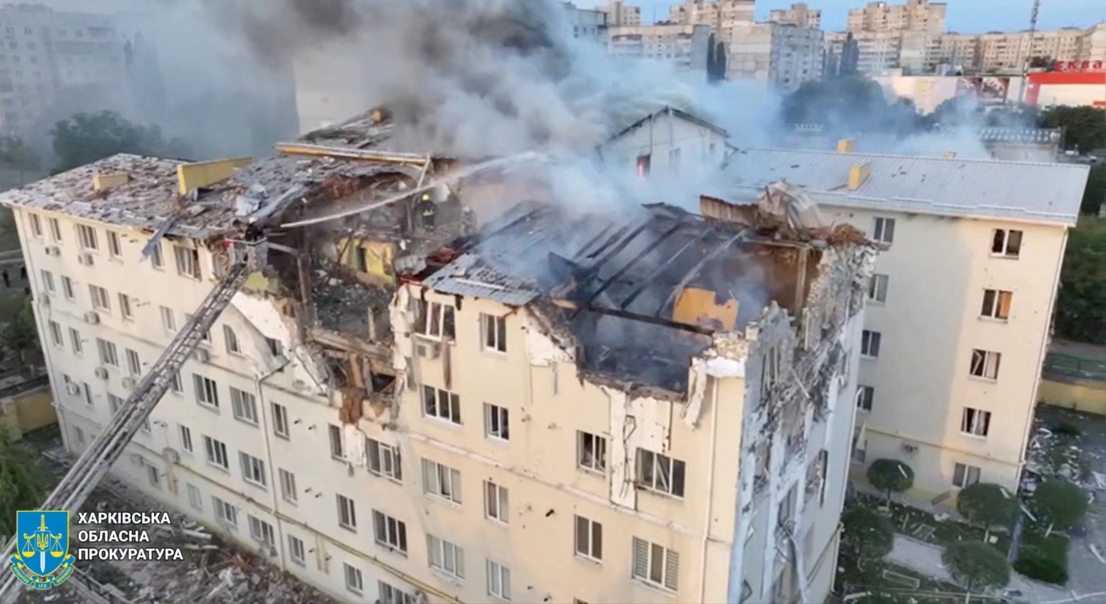 A drone view shows smoke rising from damaged buildings, at the site of an apartment building hit by a Russian drone strike in Kharkiv