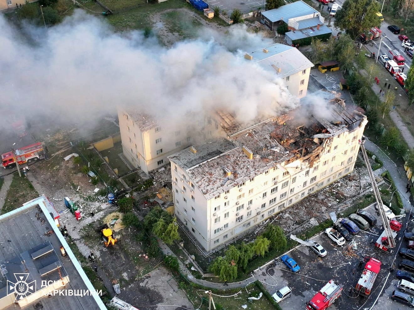 Smoke rises from damaged buildings, at the site of the Russian drone strike, amid Russia's attack on Ukraine, in Kharkiv, August 18
