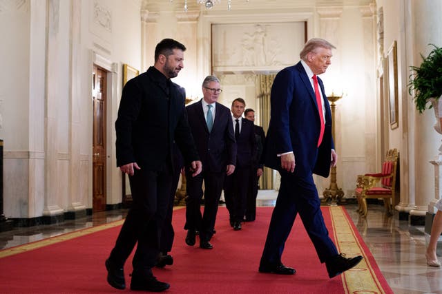 United States President Donald Trump leads Ukrainian President Volodymyr Zelensky in the Cross Hall of the White House in Washington DC (Aaron Schwartz/PA)