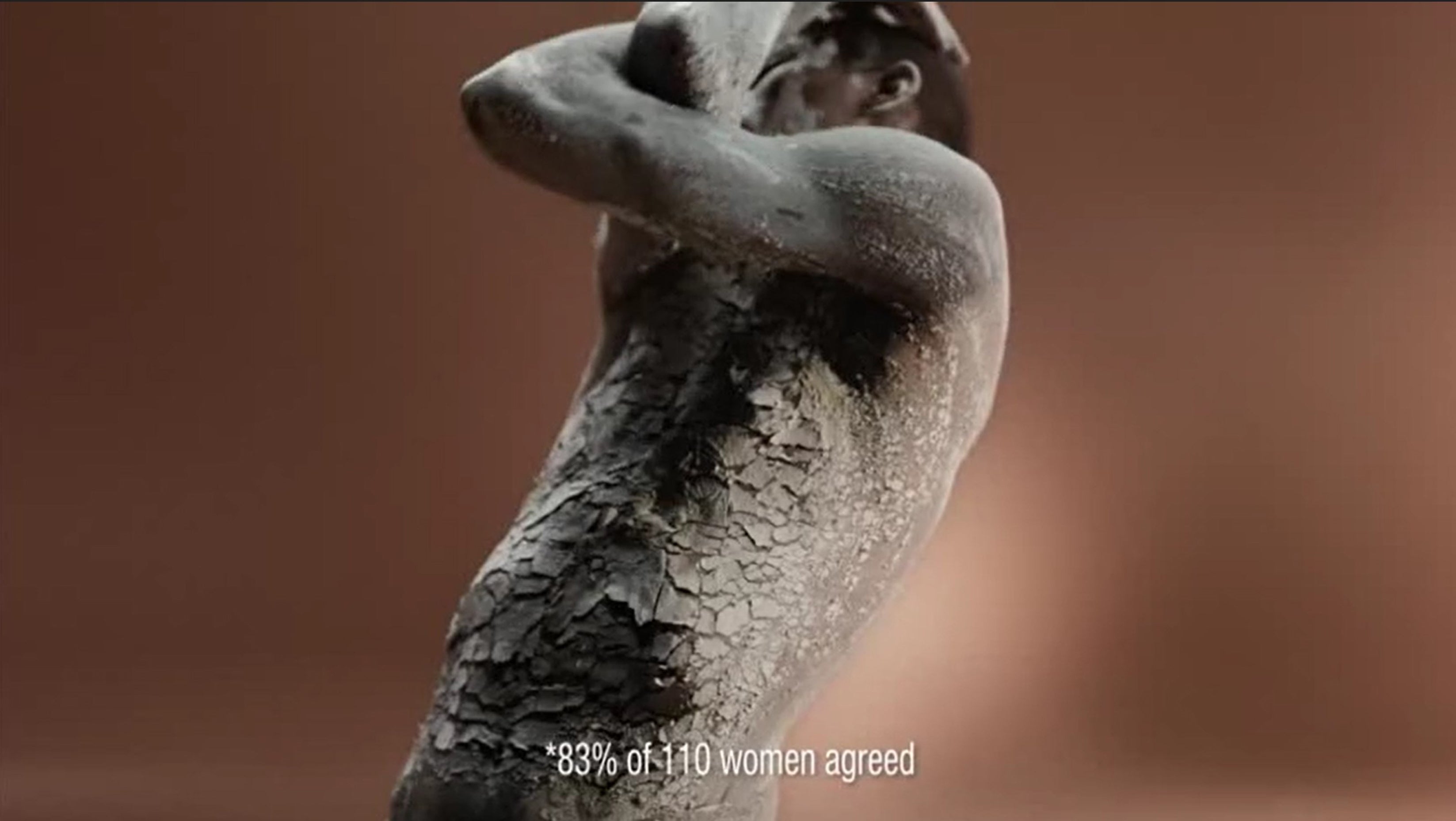In one section a black woman was shown covered in a cracked, clay-like material