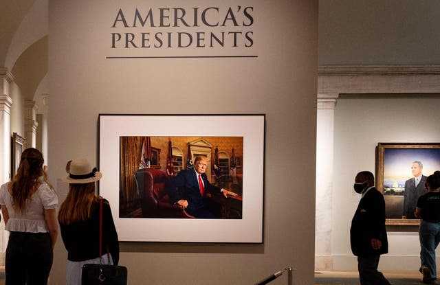 <p>A photograph of President Donald Trump hangs on the wall at the Smithsonian National Portrait Gallery in Washington, DC</p>