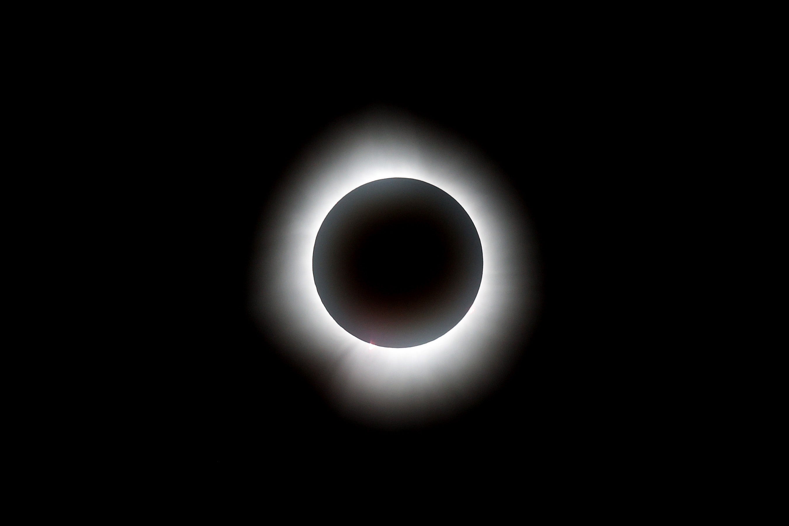 While you can’t actually see a black moon as it happens, a solar eclipse has a similar effect. The moon passes between the sun and the Earth