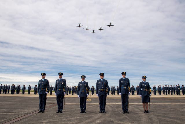 <p>This handout photo taken on 1 November 2023 and made available on 18 August 2025 by the New Zealand Defence Force shows T-6C Texan aircraft flying above a graduating parade at the Royal New Zealand Air Force (RNZAF) Base Ohakea, located north-west of the city of Palmerston North in New Zealand. - A military court found a New Zealand soldier guilty of attempted espionage for a foreign power on 18 August 2025</p>