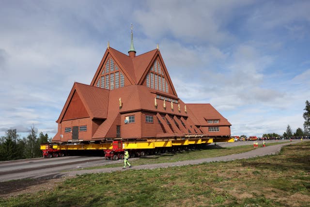<p>Kiruna's old wooden church is moved during a two-day relocation trip to a new site next to a cemetery, to save its wooden walls from ground subsidence and the expansion of the world's largest underground iron ore mine, in Kiruna, Sweden</p>