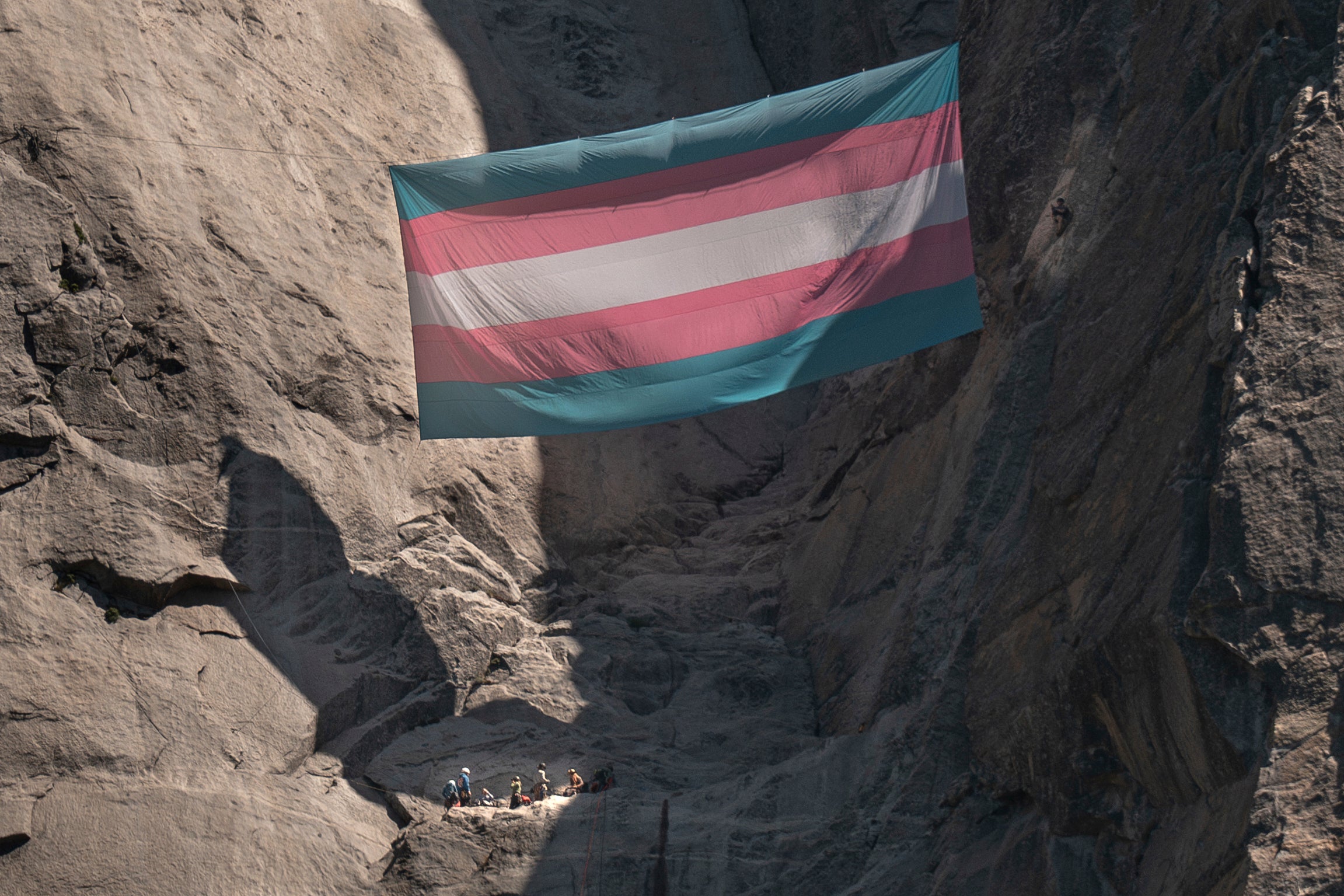 A group of people, including Shannon Joslin, a Yosemite National Park ranger and biologist who was fired, hang a transgender flag on El Capitan in Yosemite National Park, Calif., May 20, 2025