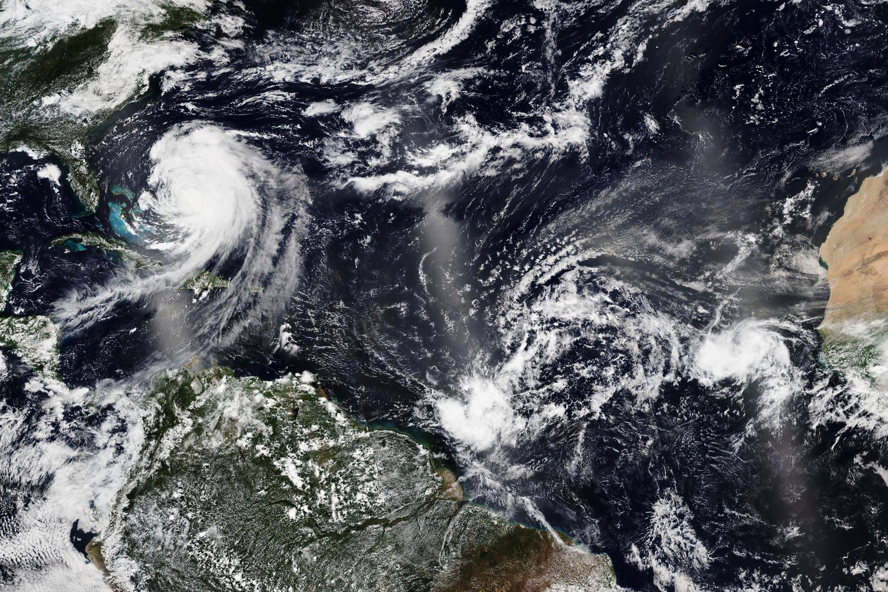 Satellite images released by NASA shows Hurricane Erin moving away from the U.S. coast