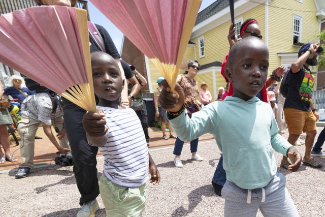 <p>Levis Martin, left, and his brother Daniel dance with fans during a Juneteenth celebration in Portsmouth, N.H, on June 19, 2025. (AP Photo/Michael Dwyer, File)</p>