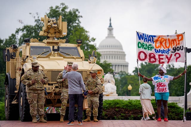 <p>Protesters speak with National Guard troops outside Union Station on August 20 in Washington, D.C.</p>